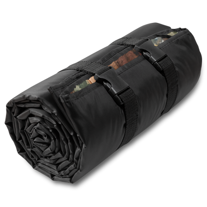 Angle of rolled up Crescent City California outdoor blanket featuring redwood trees, ocean cliffs, and a lighthouse with a plush fleece top and water-resistant backing.