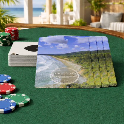 Souvenir playing cards with Crescent City, CA overlook scenic design on a green table with poker chips.