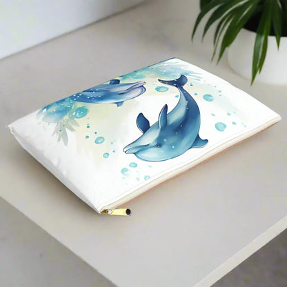 Our Dancing Dolphins Accessory Pouch constructed from a durable material with a zipper closure featuring two dolphins splashing out of the water on a white background. Available in small or large.