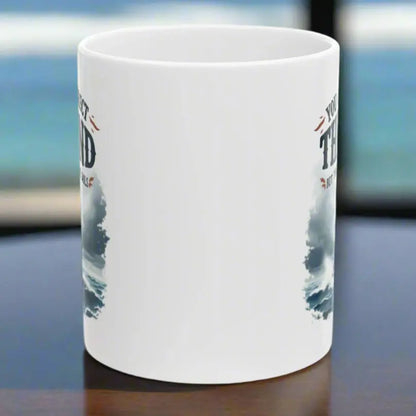 Side View of a white 11 oz. mug with a sailboat on the ocean with text 'You Can't Direct the Wind But You Can Adjust the Sails' with personalized name.