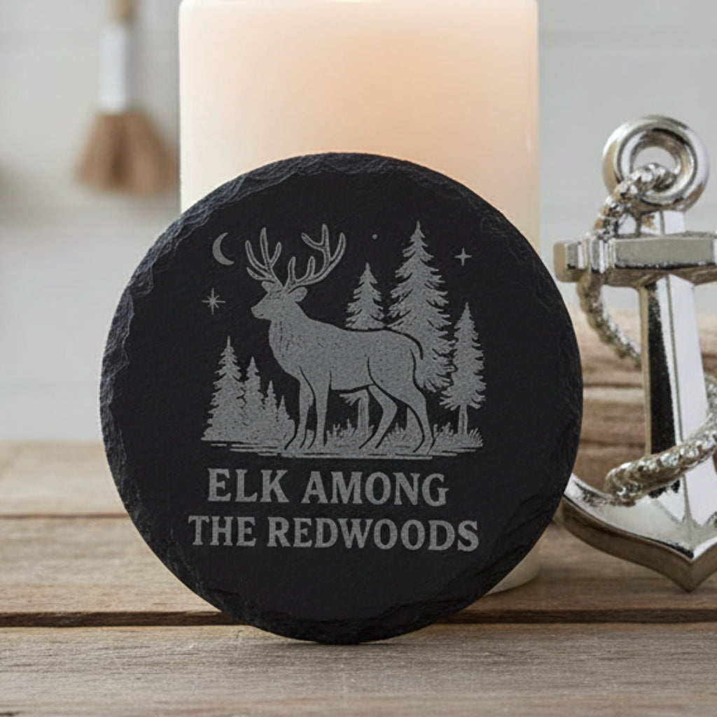 Decorative stone with engraved design of an elk among redwoods and text 'Elk Among the Redwoods'.