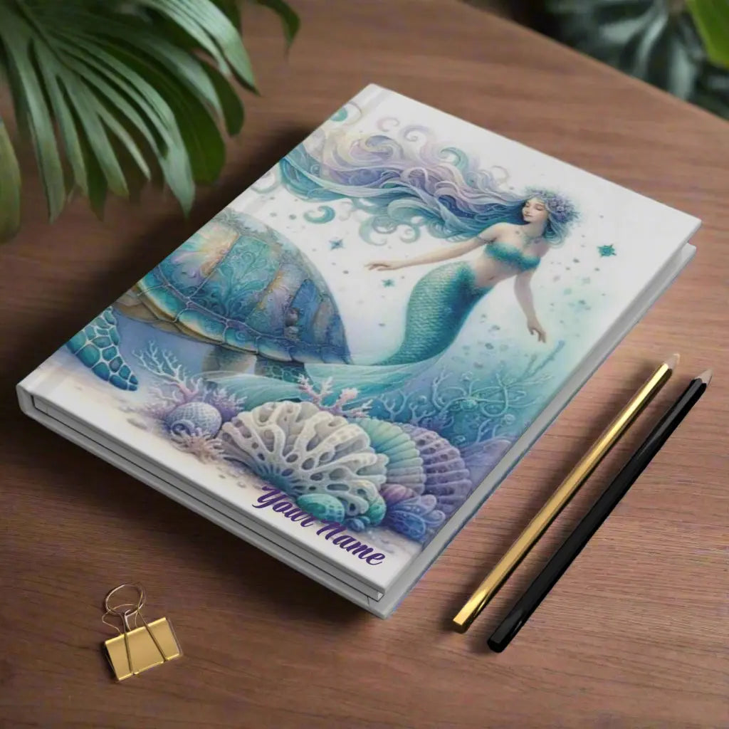 Hardcover Journal with mermaid and sea turtle underwater with sea shells and plant life in purple and aqua colors.