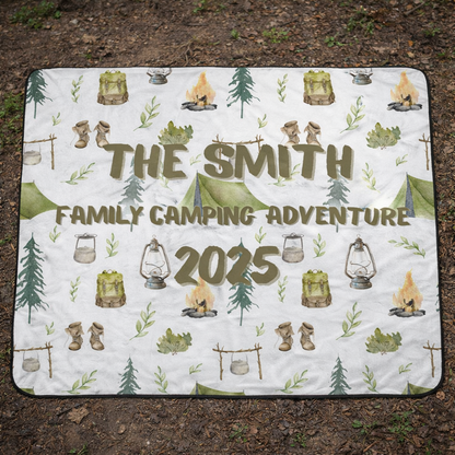 Camping-themed blanket with 'The Smith Family Camping Adventure 2025' text on a natural background.