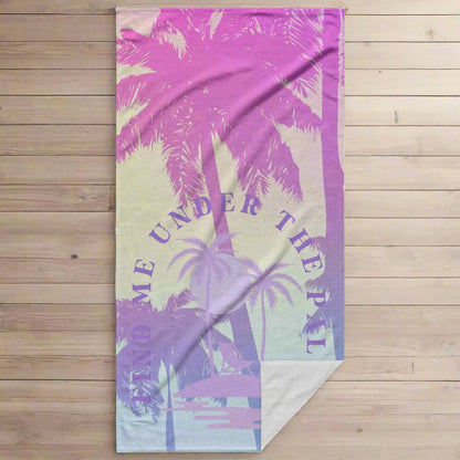 Beach towel with purple and pink beach design with palm trees and lounge chair on beach with text Find Me Under the Palms.