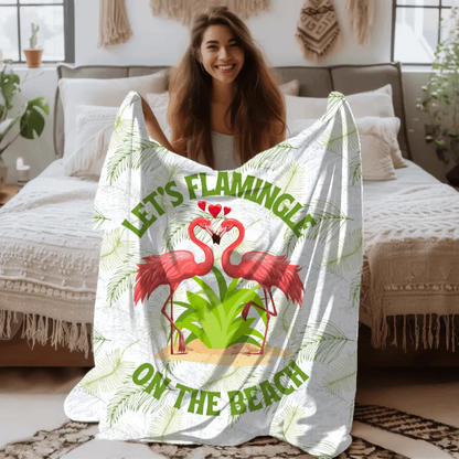 White velveteen plush blanket with green palm fronds and two flamingos in a heart shape that says Let's Flamingle. -perfect for snuggling on cold nights or as a comforting gift for a loved one who is a beach lover.