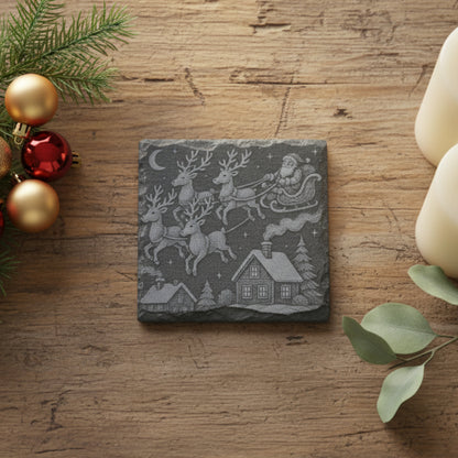 Engraved slate 4" square coaster with a Christmas design of Santa Claus in a sleigh pulled by reindeer over homes.