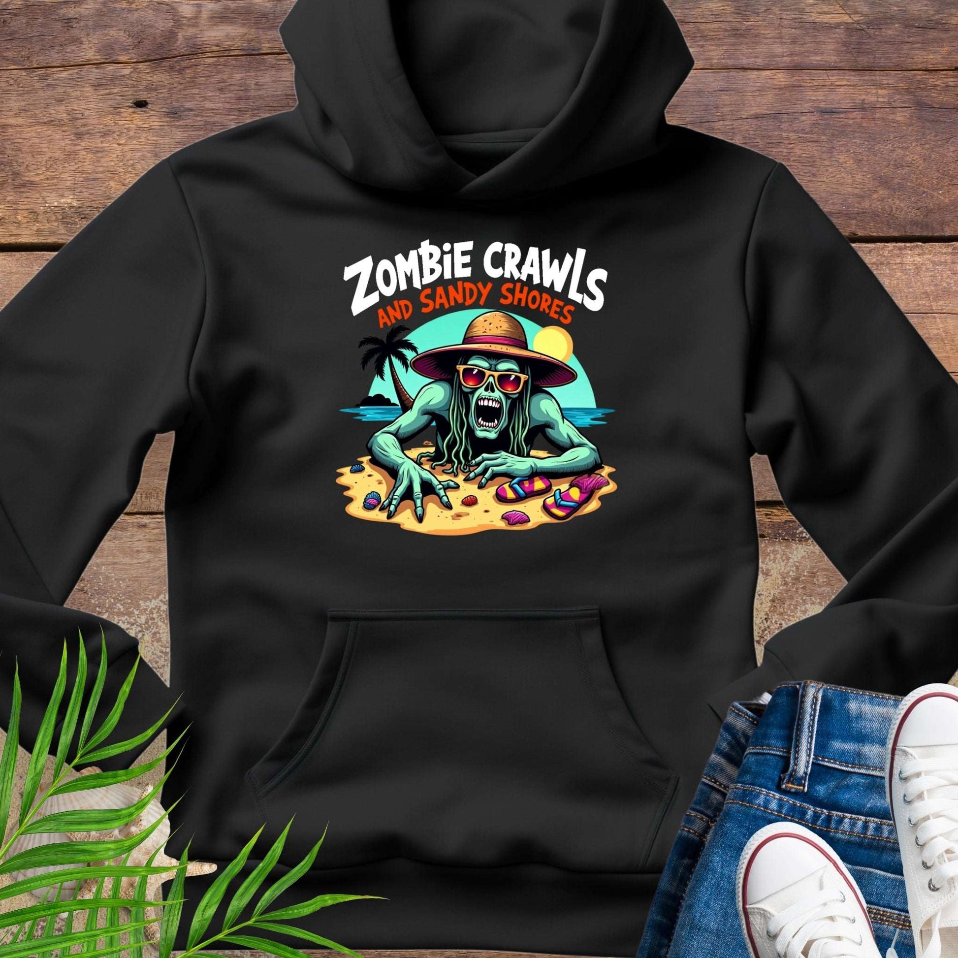 Black hoodie with a graphic design of a zombie on sandy shores, placed on a wooden surface.
