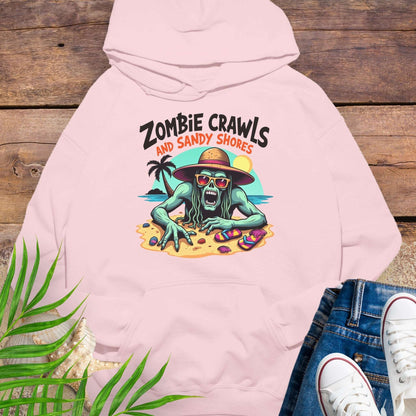 Pink hoodie with zombie graphic and text 'Zombie Crawls and Sandy Shores' on a wooden surface.