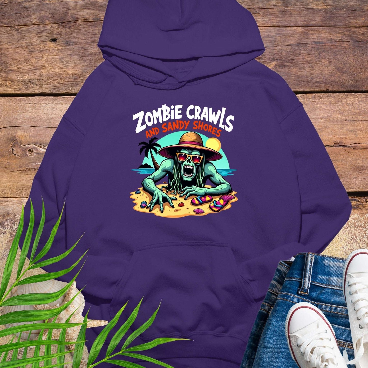Purple hoodie with a zombie and beach graphic on a wooden surface