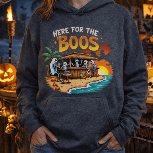 Person wearing a hoodie with 'Here for the Boos' graphic in a Halloween-themed setting.