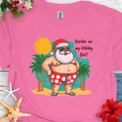 Azalea T-shirt with Santa with swim shorts on the beach with text Workin' on my Holiday Bod'!