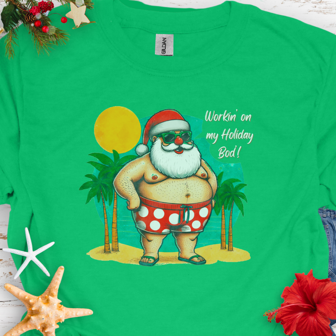 Green T-shirt with Santa with swim shorts on the beach with text Workin' on my Holiday Bod'!