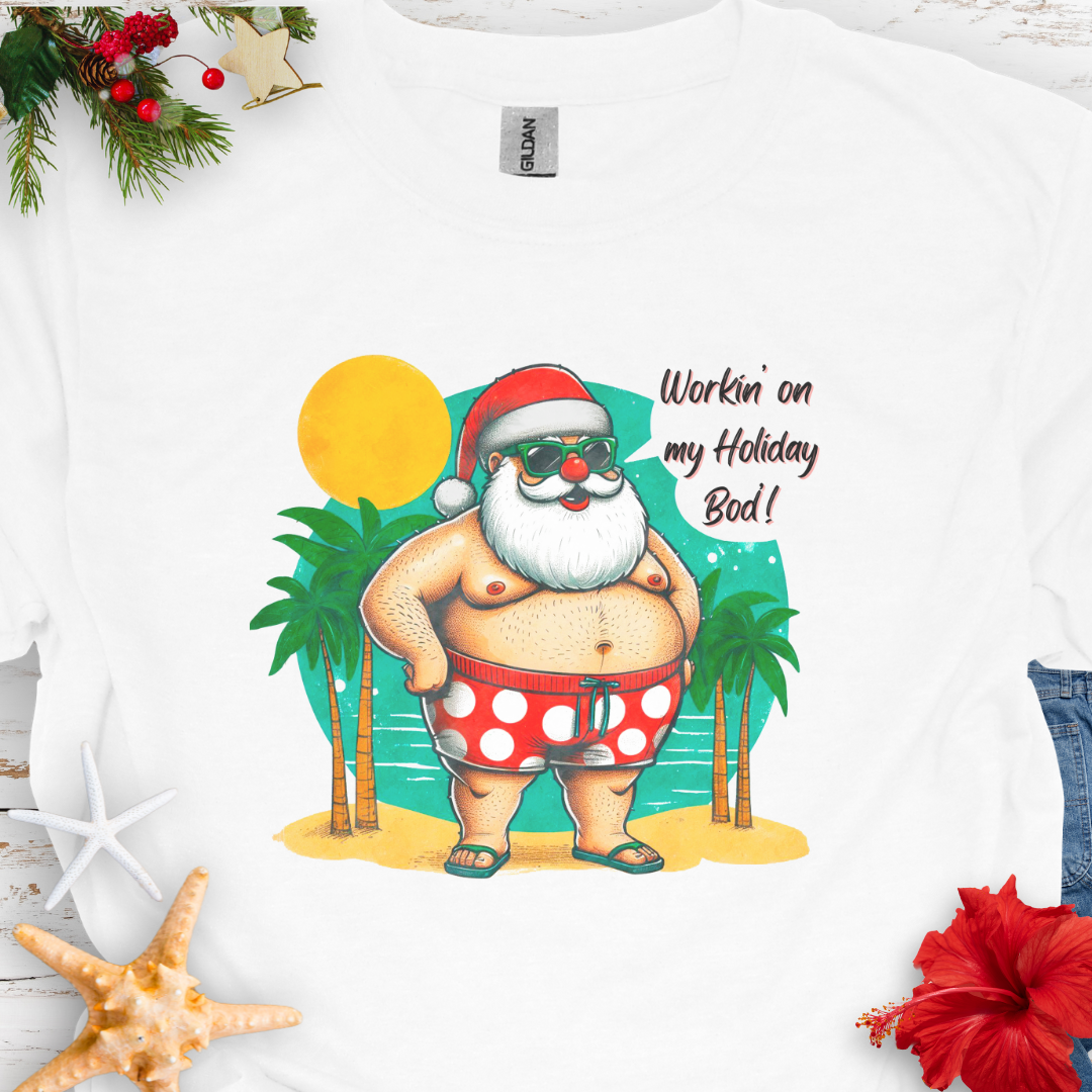 White T-shirt with Santa with swim shorts on the beach with text Workin' on my Holiday Bod'!