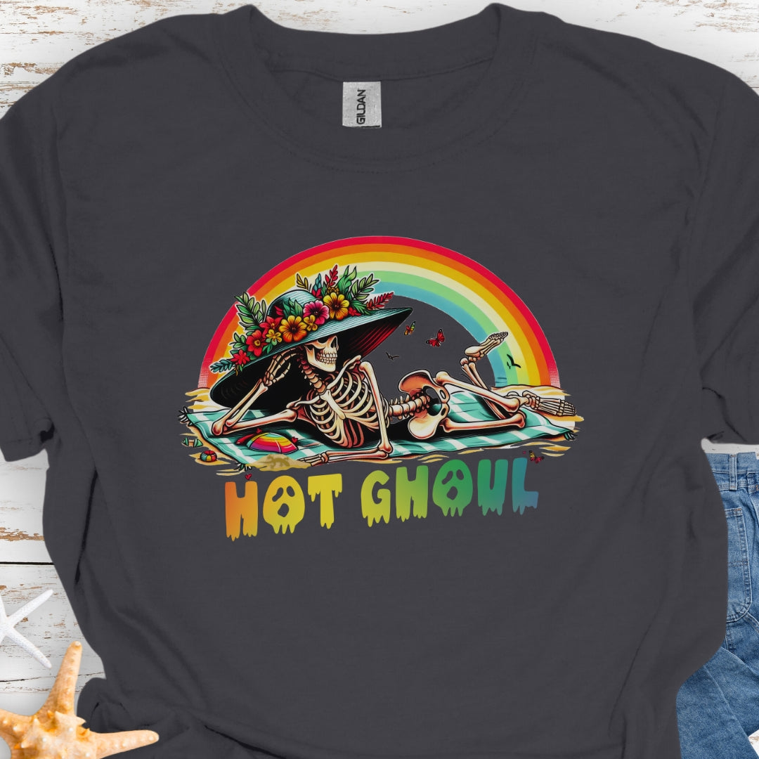 Charcoal  t-shirt with a girl skeleton laying on beach towel with flowered hat and rainbow with rainbow dripping text that says Hot Ghoul.