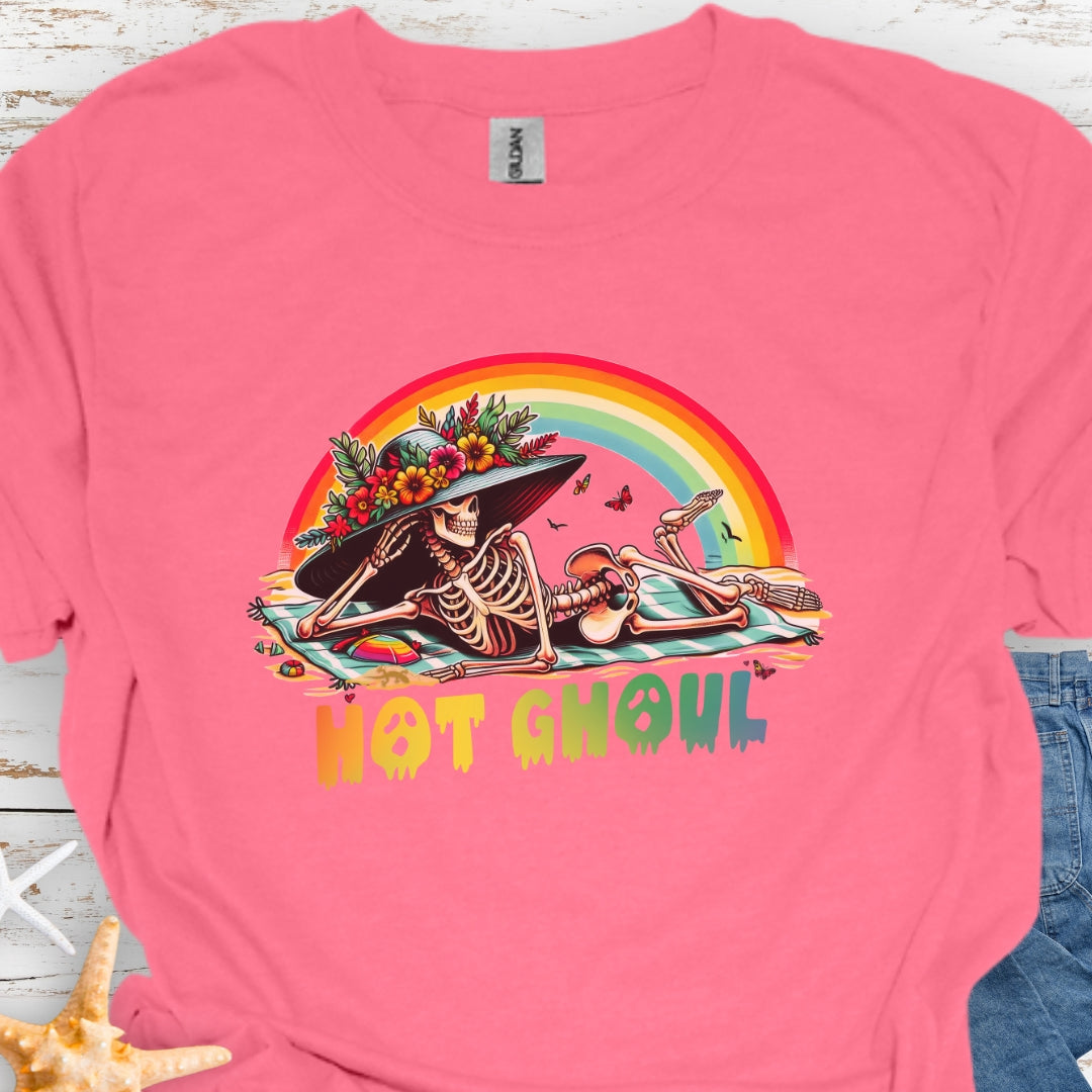 Coral Silk  t-shirt with a girl skeleton laying on beach towel with flowered hat and rainbow with rainbow dripping text that says Hot Ghoul.