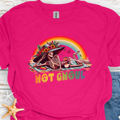 Heliconia  t-shirt with a girl skeleton laying on beach towel with flowered hat and rainbow with rainbow dripping text that says Hot Ghoul.