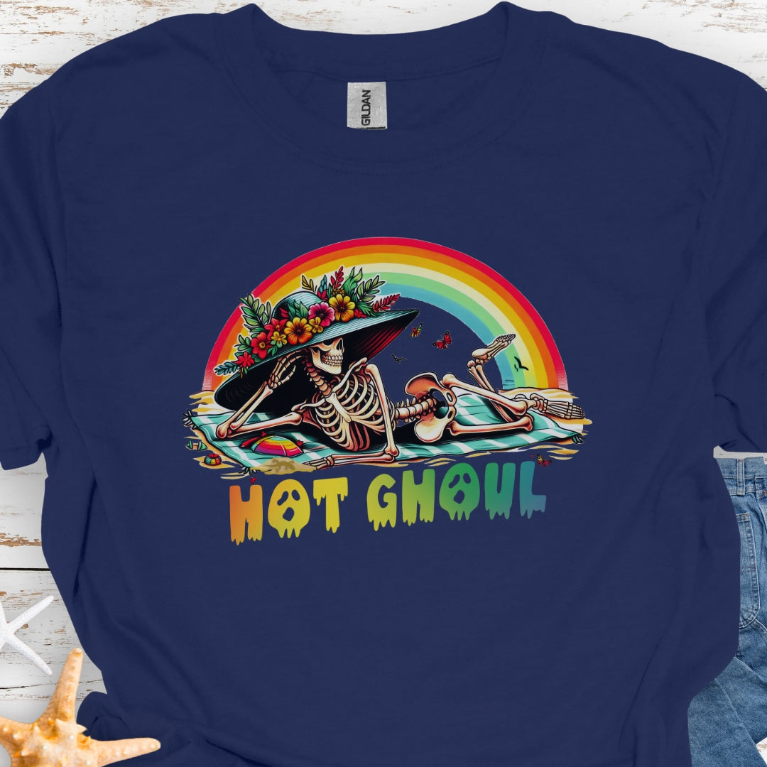 Navy  t-shirt with a girl skeleton laying on beach towel with flowered hat and rainbow with rainbow dripping text that says Hot Ghoul.