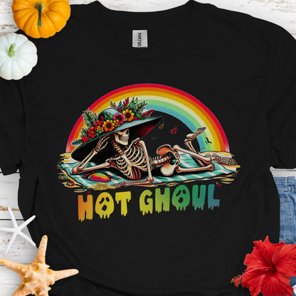 Black  t-shirt with a girl skeleton laying on beach towel with flowered hat and rainbow with rainbow dripping text that says Hot Ghoul.