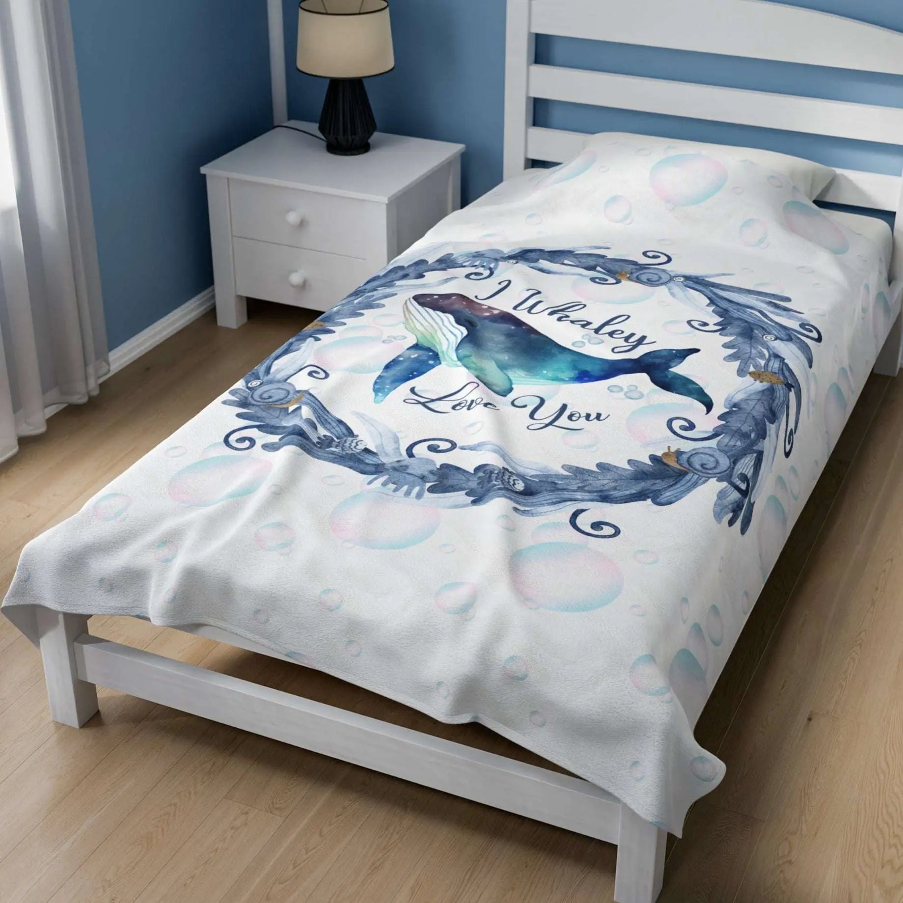 White Velveteen Plush blanket with blue marine plant wreath with swimming whale in the middle and text I Whaley Love You -perfect for snuggling up with your beachy loved ones!