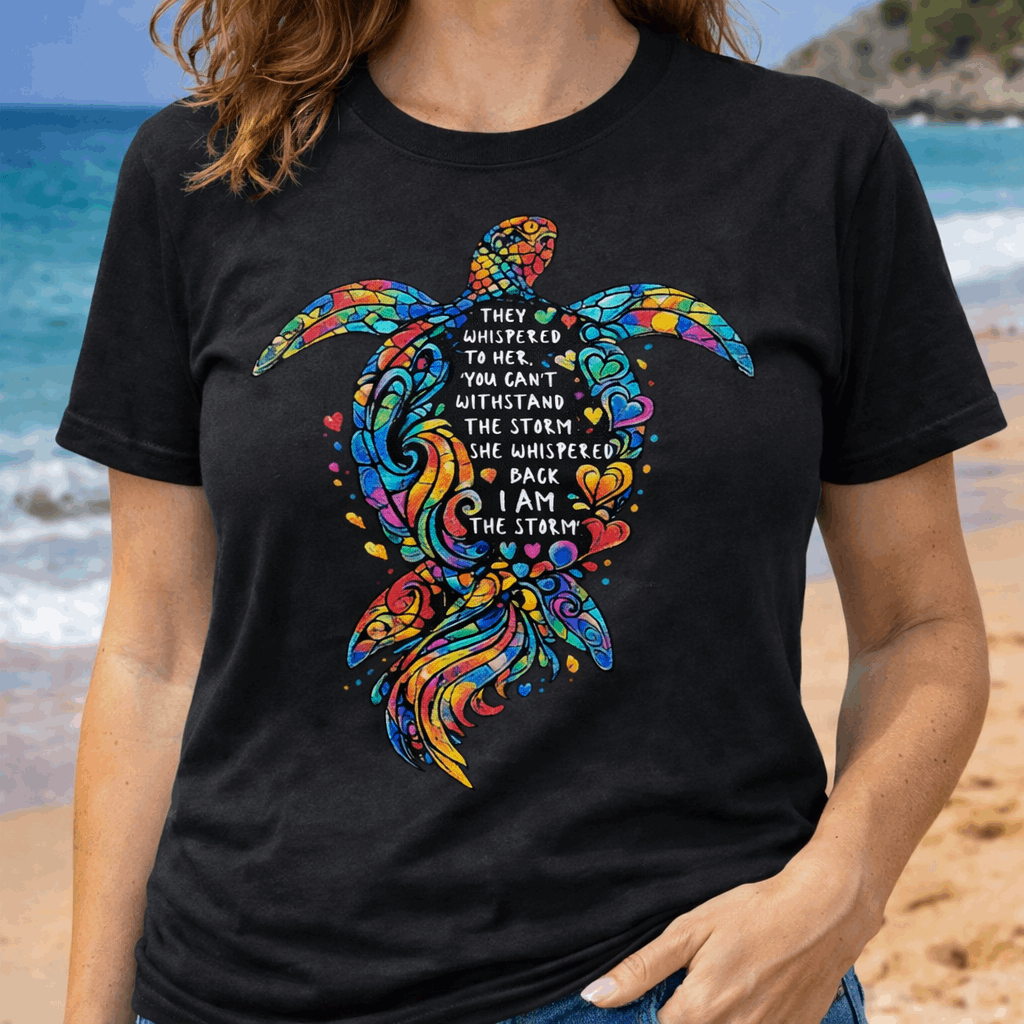 Person wearing a black Unisex sea turtle shirt with empowering quote “I Am the Storm” and hand-drawn ocean turtle artwork