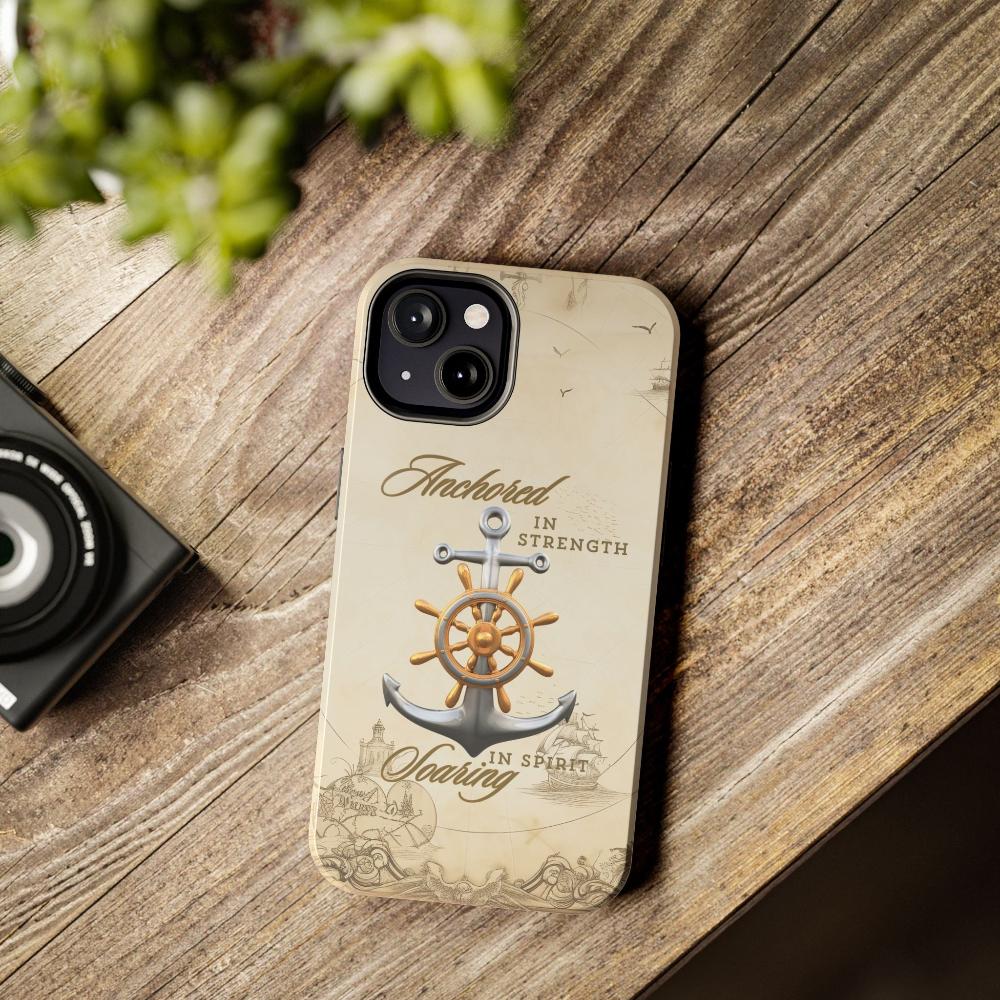 Iphone 13 Cell phone cover Silver Anchor with silver and gold ship wheel on top with text Anchored in strength Soaring in Spirit on beige nautical map background.