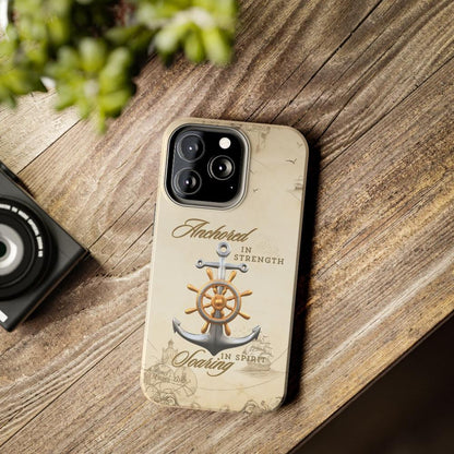 Iphone 13 Pro Cell phone cover Silver Anchor with silver and gold ship wheel on top with text Anchored in strength Soaring in Spirit on beige nautical map background.