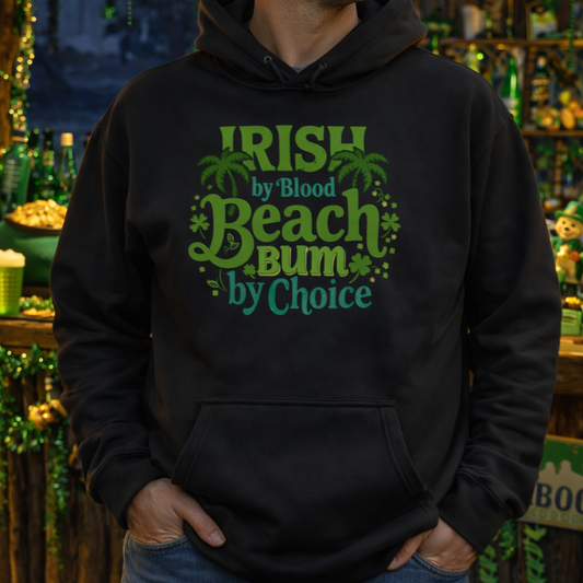 Person wearing a black hoodie with 'Irish by Blood, Beach Bum by Choice' text in a festive setting.