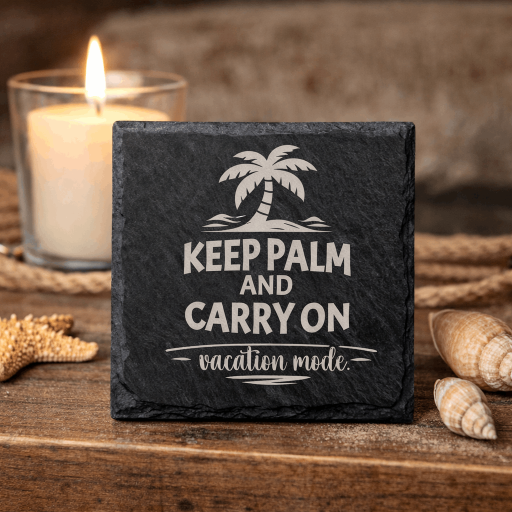 Square black slate coaster engraved “Keep Palm and Carry On vacation mode” with palm tree icon.