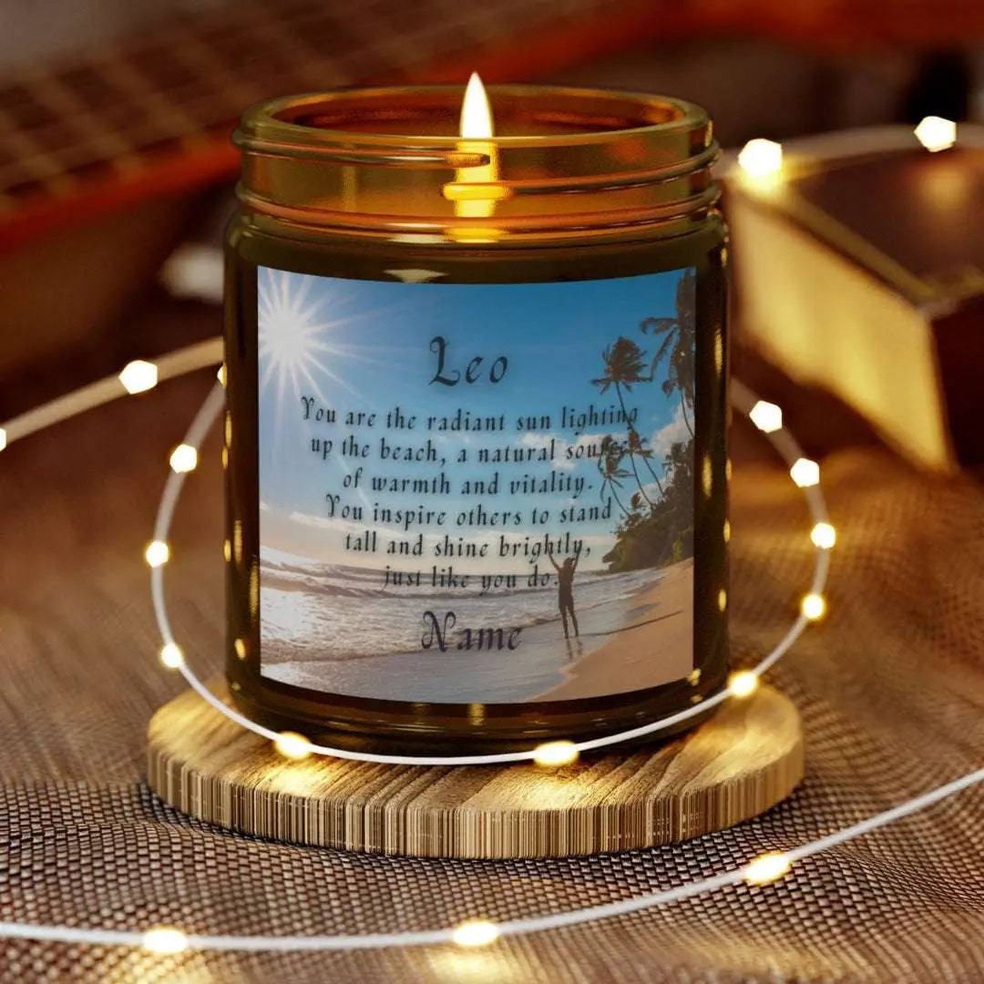 Elegant Leo Zodiac hand-poured coconut apricot wax scented candle in a 9 oz amber glass jar, featuring a picture of the ocean and beach with palm trees and woman raising her hands to the sun with an inspirational quote personalized. A beach-inspired astrology gift, perfect for relaxation and decor.