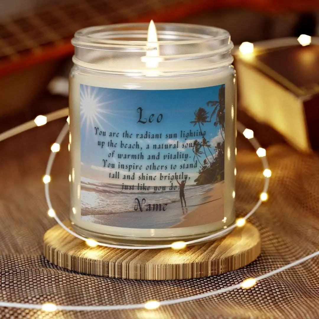 Elegant Leo Zodiac hand-poured coconut apricot wax scented candle in a 9 oz clear glass jar, featuring a picture of the ocean and beach with palm trees and woman raising her hands to the sun with an inspirational quote personalized. A beach-inspired astrology gift, perfect for relaxation and decor.