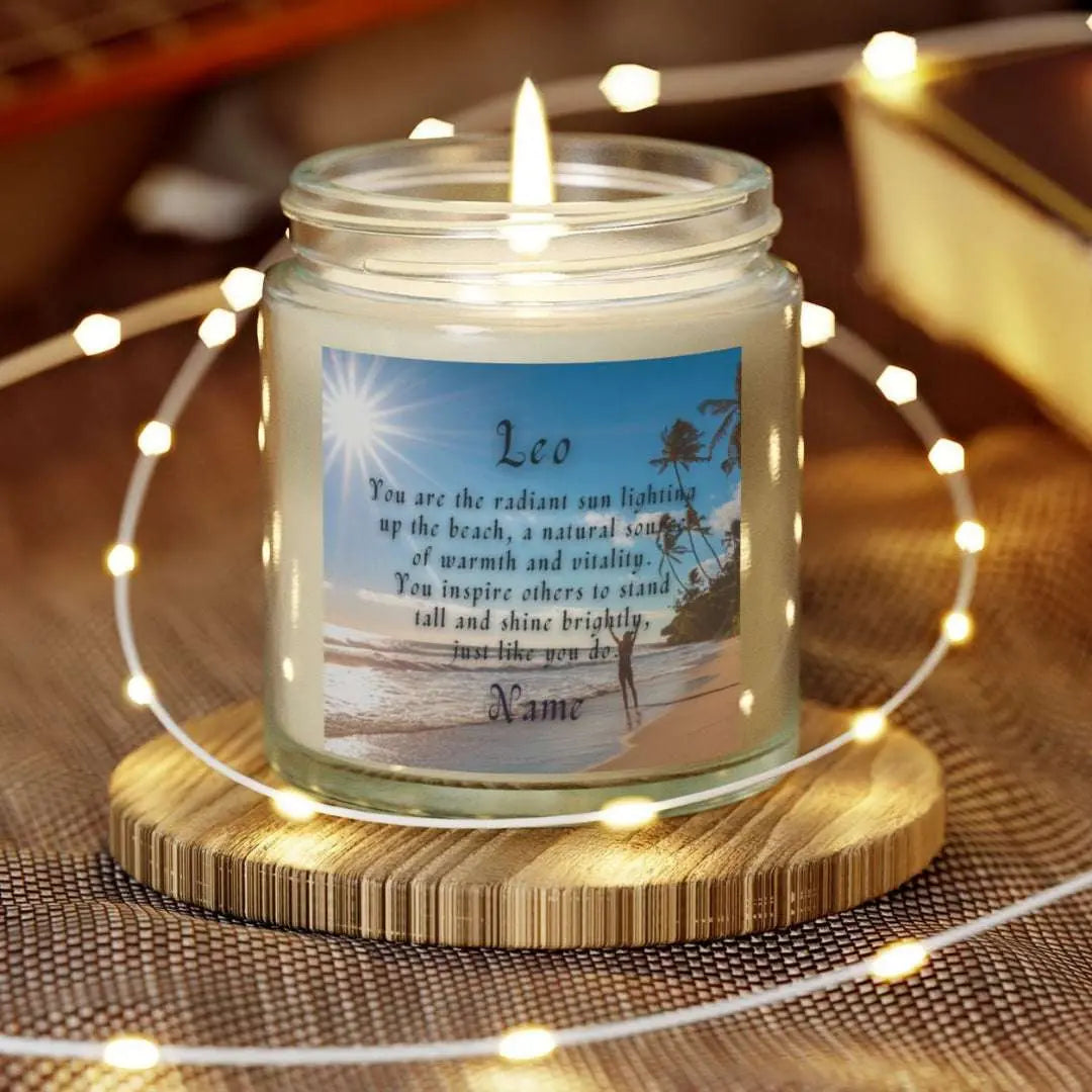 Elegant Leo Zodiac hand-poured coconut apricot wax scented candle in a 4 oz clear glass jar, featuring a picture of the ocean and beach with palm trees and woman raising her hands to the sun with an inspirational quote personalized. A beach-inspired astrology gift, perfect for relaxation and decor.