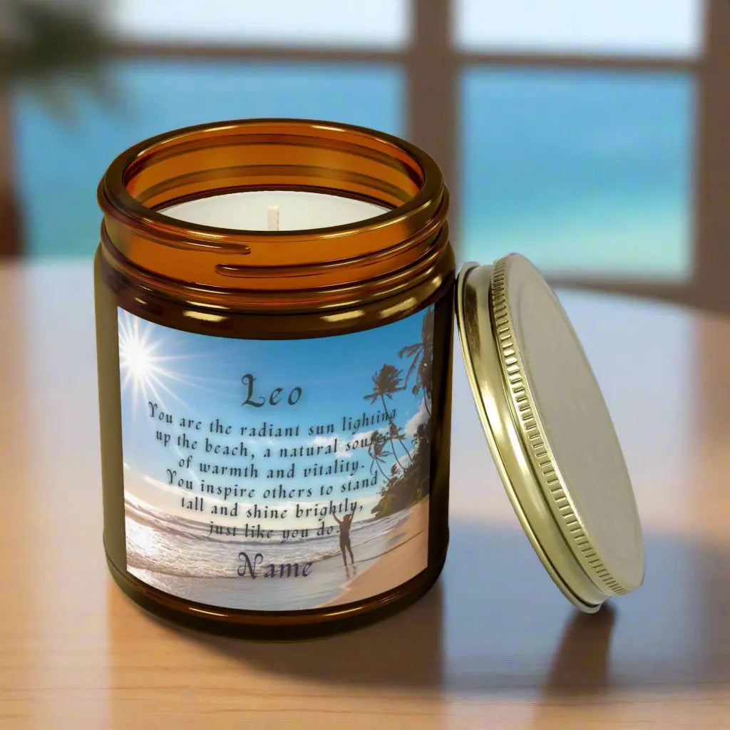 Elegant Leo Zodiac hand-poured coconut apricot wax scented candle in a 9 oz amber glass jar, featuring a picture of the ocean and beach with palm trees and woman raising her hands to the sun with an inspirational quote personalized. A beach-inspired astrology gift, perfect for relaxation and decor.