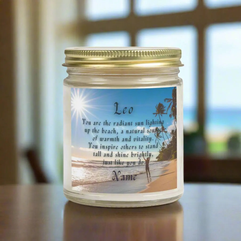 Elegant Leo Zodiac hand-poured coconut apricot wax scented candle in a 9 oz clear glass jar, featuring a picture of the ocean and beach with palm trees and woman raising her hands to the sun with an inspirational quote personalized. A beach-inspired astrology gift, perfect for relaxation and decor.