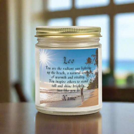 Elegant Leo Zodiac hand-poured coconut apricot wax scented candle in a 9 oz clear glass jar, featuring a picture of the ocean and beach with palm trees and woman raising her hands to the sun with an inspirational quote personalized. A beach-inspired astrology gift, perfect for relaxation and decor.