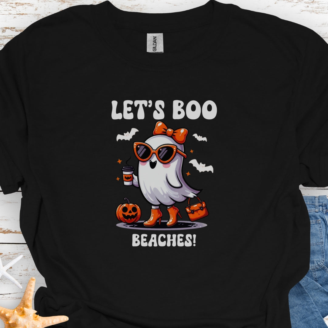 Black  t-shirt with a girl ghost wearing sunglasses, high heels and an orange bow in hair holding a purse and coffee with bats flying around with text Let's Boo Beaches' 