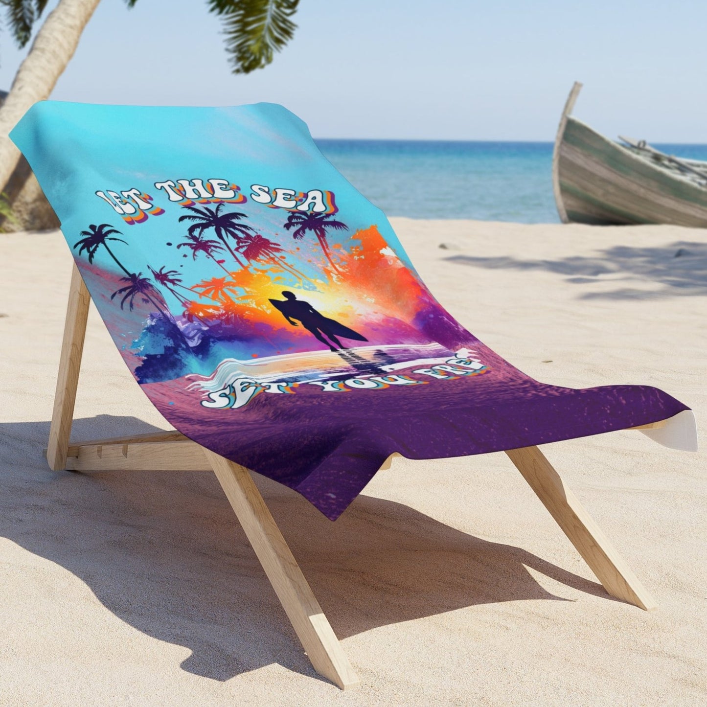 a beach towel that has a purple wave and blue sky with the words Let the Sea Set You Free laying over beach chair.