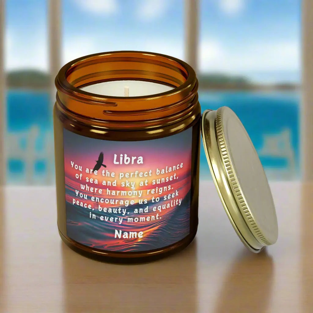 Elegant LIbra Zodiac hand-poured coconut apricot wax scented candle in a 9 oz amber glass jar with gold lid, featuring a scene of the ocean at sunset with bird flying in the sky with an inspirational quote personalized. A beach-inspired astrology gift, perfect for relaxation and decor.
