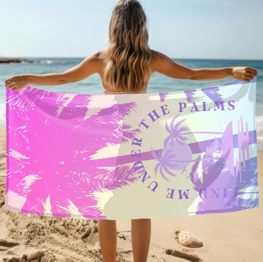 Beach towel with purple and pink beach design with palm trees and lounge chair on beach with text Find Me Under the Palms.