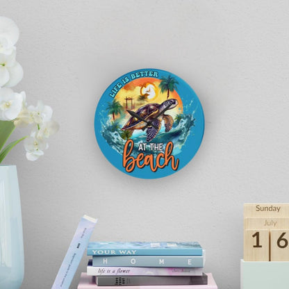 Round clock with Sea turtle swimming with sunset behind and text Life is better at the beach