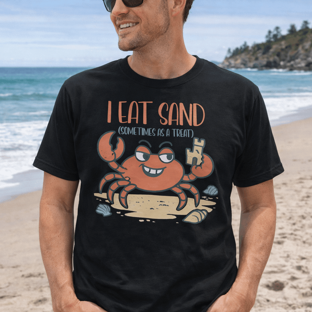 A man wearing a black t-shirt with a cartoon crab design and text 'I Eat Sand (Sometimes as a Treat)'.