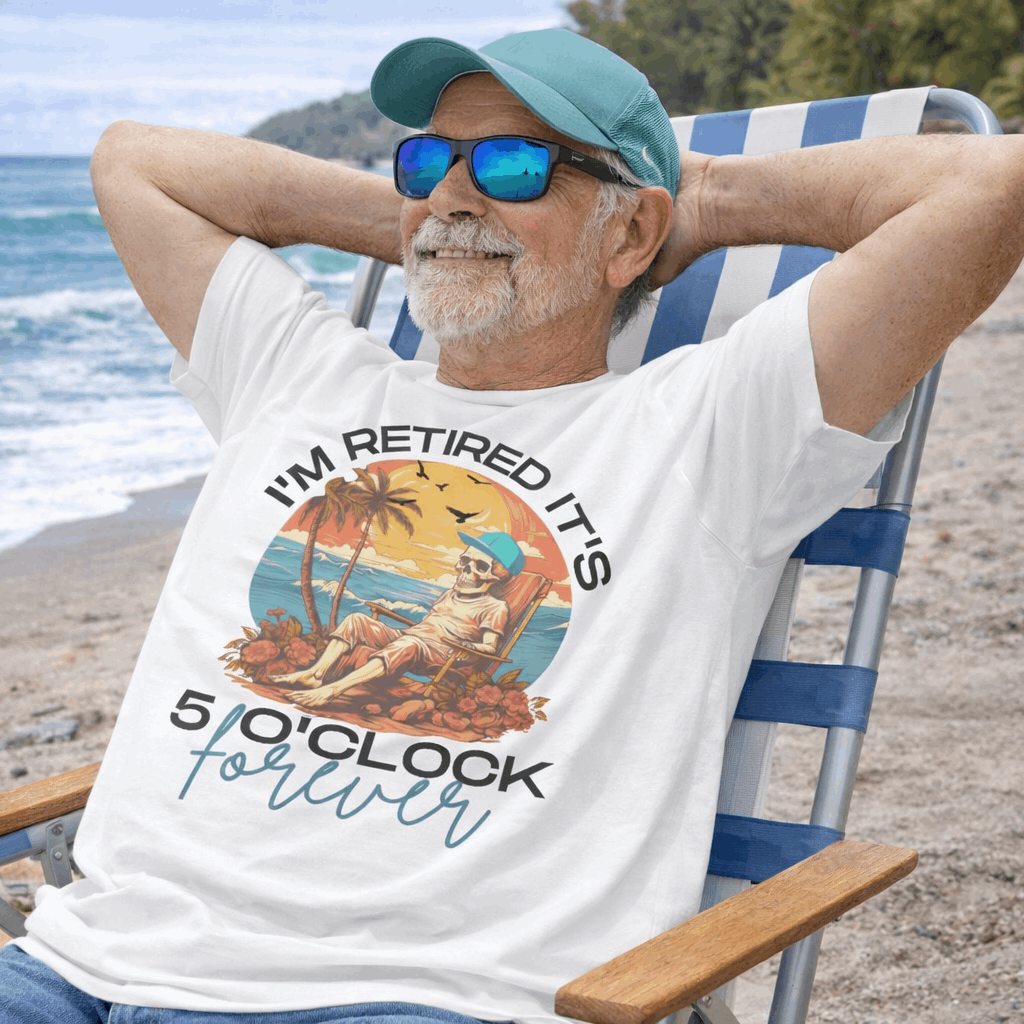 A white t-shirt with a skeleton man lounging at the beach with the text I'm retired it's 5 0'clock forever.