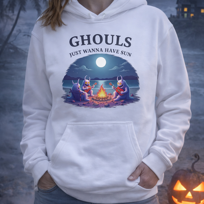 Person wearing a white hoodie with 'Ghouls Just Wanna Have Sun' design in a Halloween-themed setting.