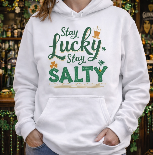 Person wearing a white hoodie with 'Stay Lucky Stay Salty' text in a casual setting.