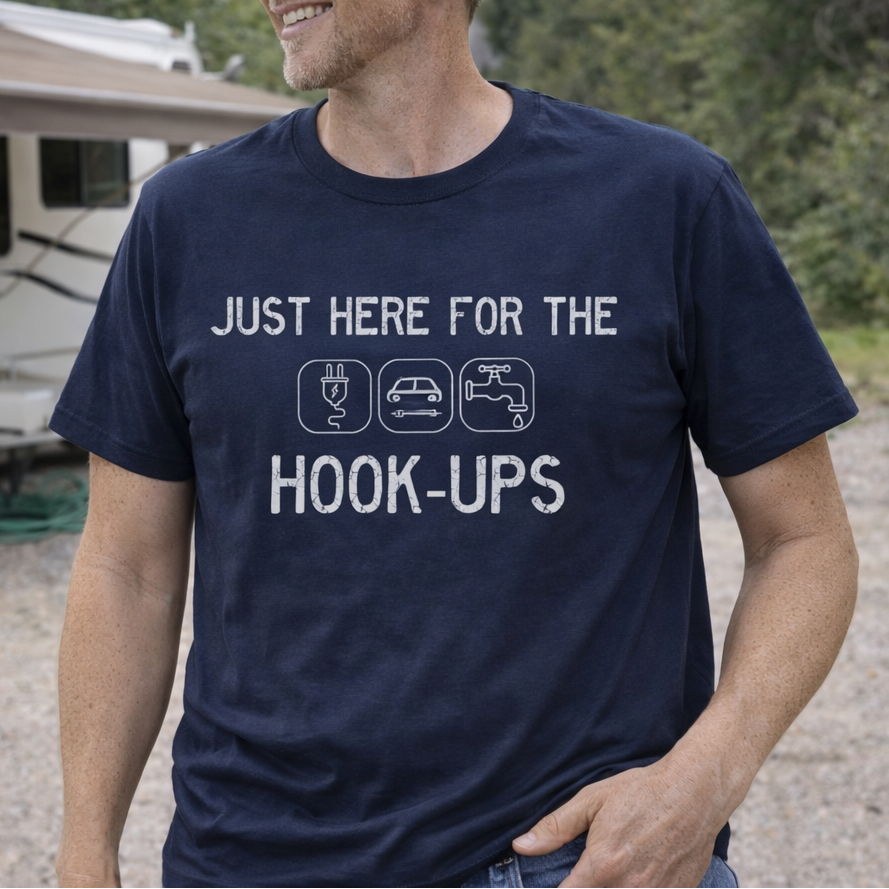 Man wearing a navy blue t-shirt with text I'm Here for the Hook-ups with RV hook-up graphics.