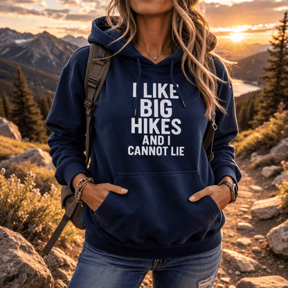 Person wearing a navy hoodie with text "I Like Big Hikes and I Cannot Lie" in a mountainous landscape