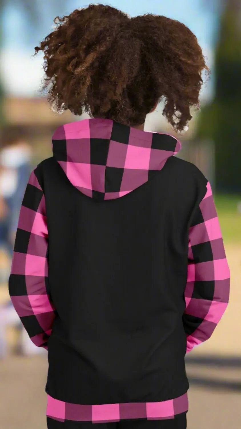 Back of black sweatshirt with hot pink and black gingham sleeves, hood and bottom cuff.