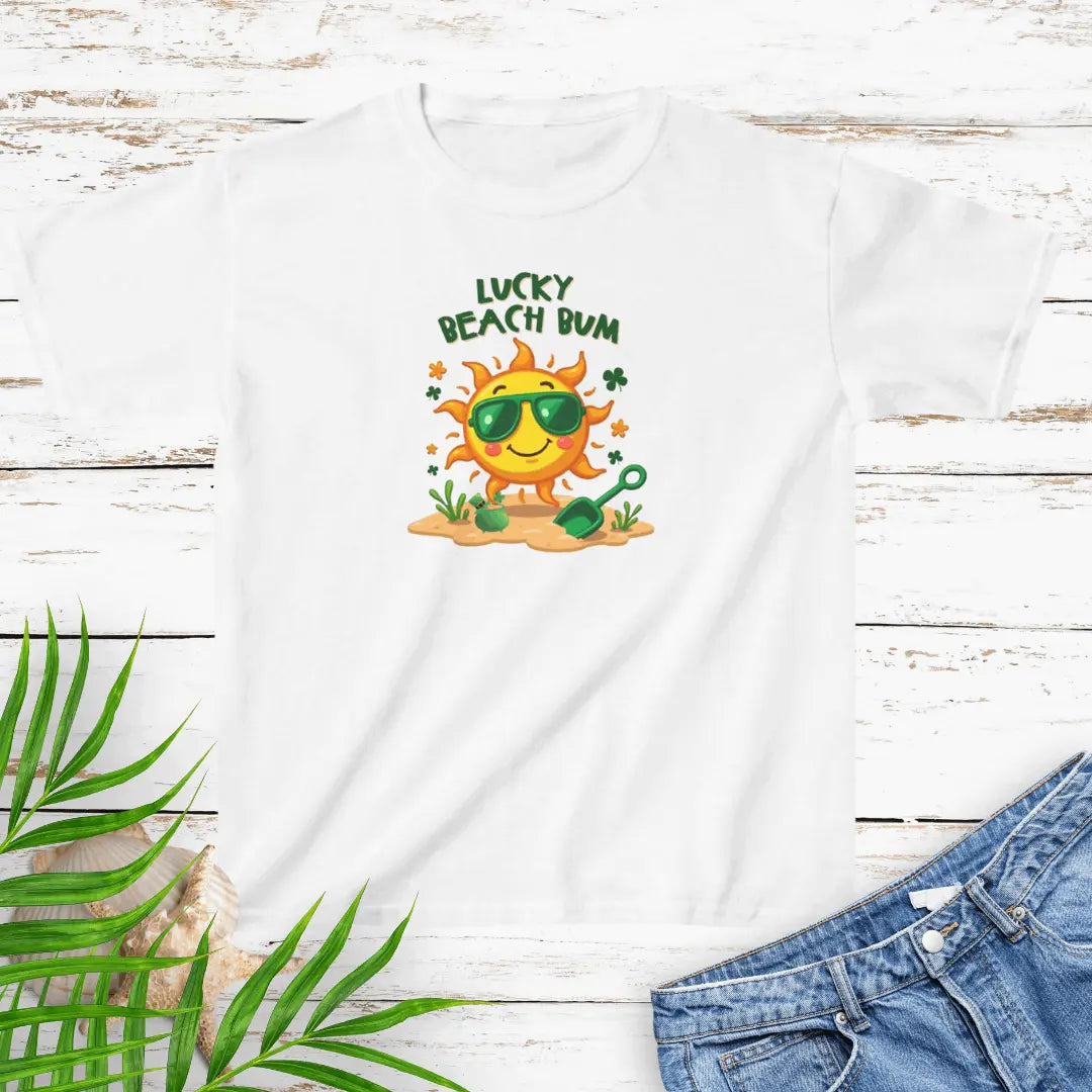 Lucky Beach Bum Child's White small T-shirt with a smiling sun wearing green sunglasses on the beach with beach toys.