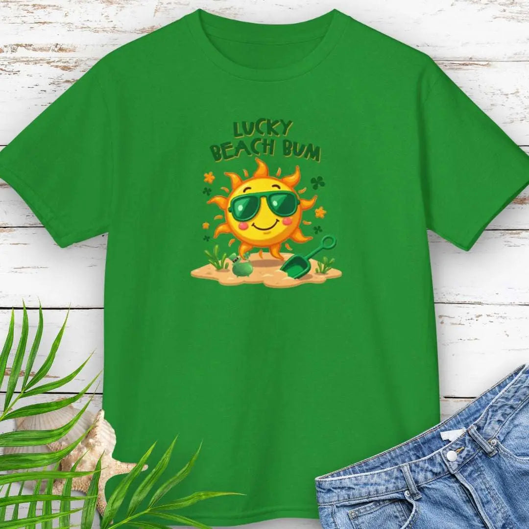 Lucky Beach Bum Child's Green T-shirt with a smiling sun wearing green sunglasses on the beach with beach toys.
