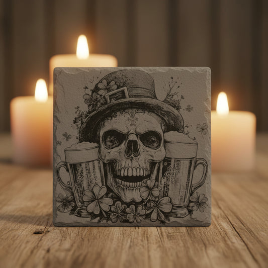 Engraved slate coaster with a skull wearing a top hat, surrounded by clovers and two beer mugs.