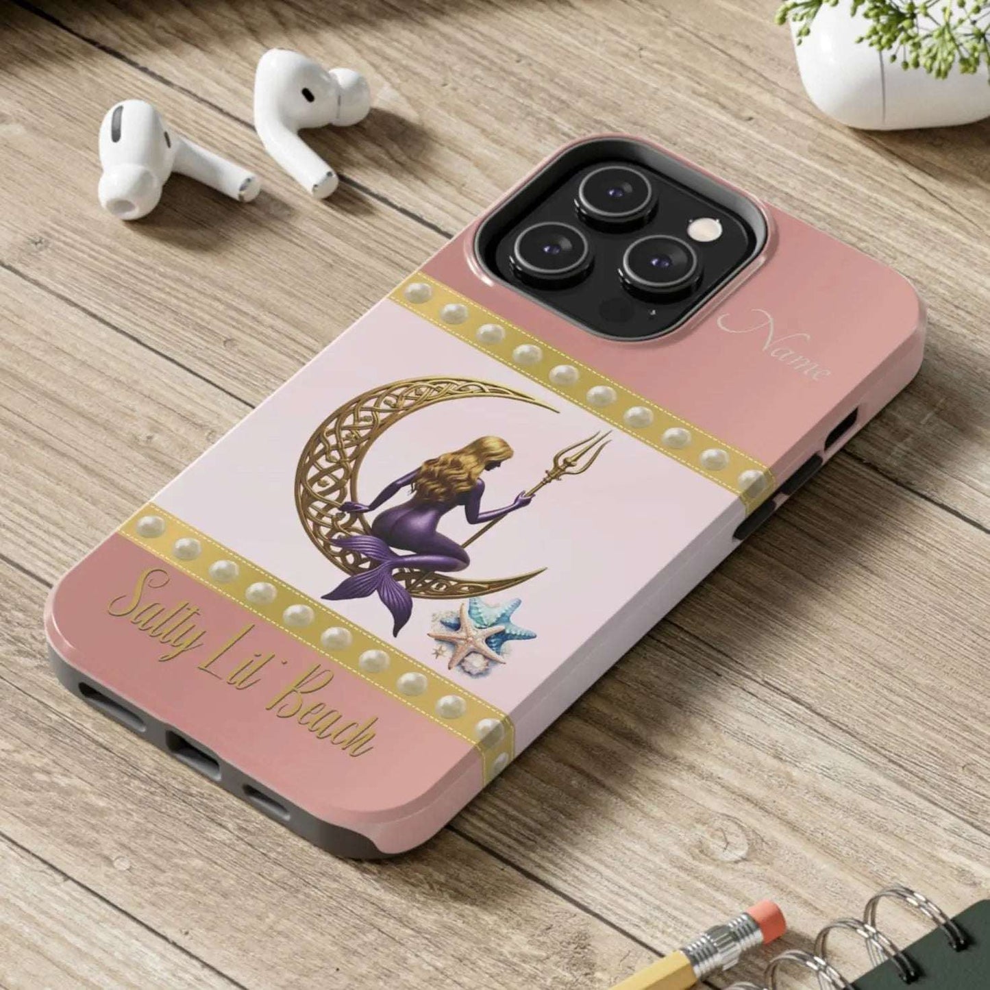 Pink and White 14 Pro iPhone Case with mermaid sitting on a celtic crescent moon holding a trident that says Salty Lil' Beach. Personalized with name.